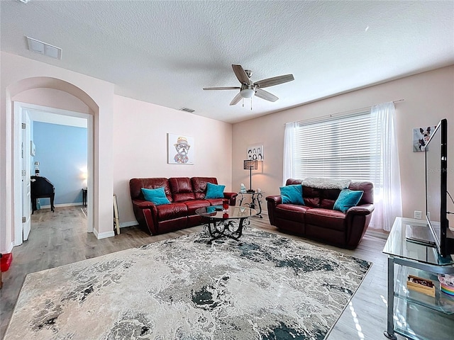 3205 Royal Tern Dr, Winter Haven, FL 33881 - living area with visible vents, arched walkways, ceiling fan, and wood finished floors