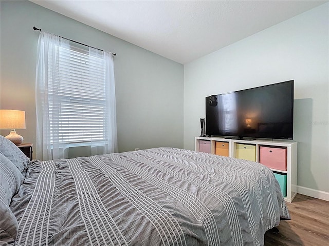 3205 Royal Tern Dr, Winter Haven, FL 33881 - bedroom featuring baseboards, light wood finished floors, and multiple windows