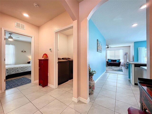 3205 Royal Tern Dr, Winter Haven, FL 33881 - hall featuring washing machine and clothes dryer, light tile patterned flooring, visible vents, and recessed lighting