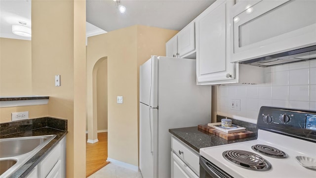 501 Knights Run Ave Unit 1335, Tampa, FL 33602 - kitchen featuring white appliances, white cabinets, decorative backsplash, and dark stone counters