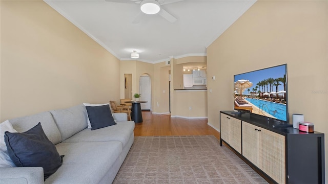 501 Knights Run Ave Unit 1335, Tampa, FL 33602 - living area featuring light wood-style flooring, ceiling fan, crown molding, arched walkways, and baseboards