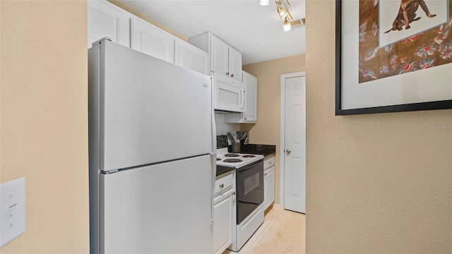 501 Knights Run Ave Unit 1335, Tampa, FL 33602 - kitchen featuring white appliances, white cabinets, dark countertops, and light marble finish floors