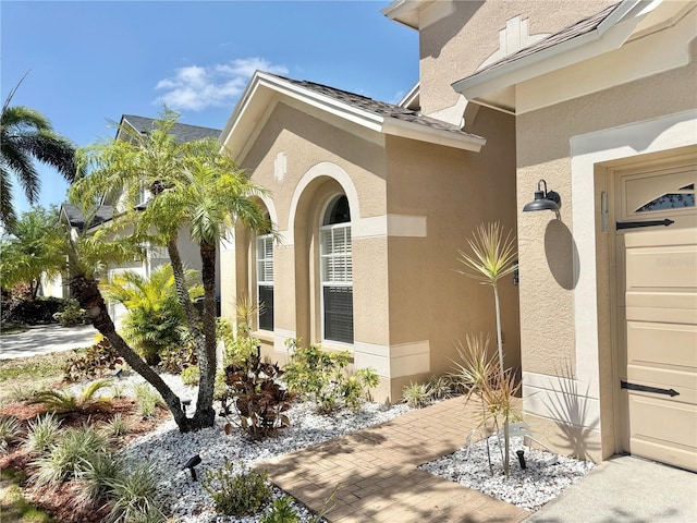 property entrance with stucco siding