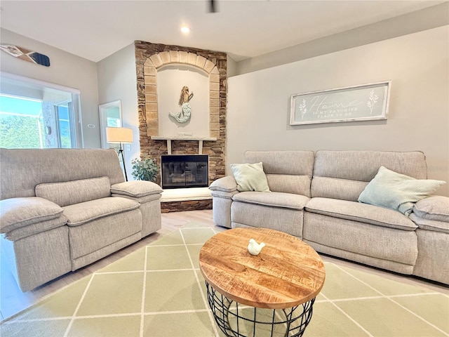living room with a fireplace and wood finished floors