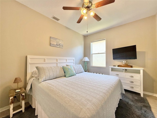 bedroom with a ceiling fan, baseboards, visible vents, and dark colored carpet