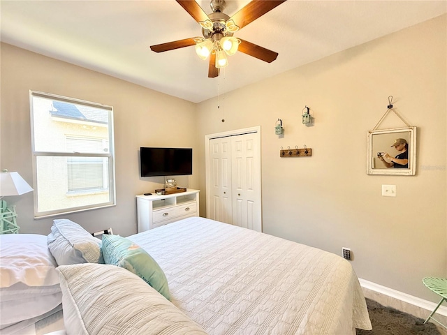 bedroom with baseboards, ceiling fan, and a closet