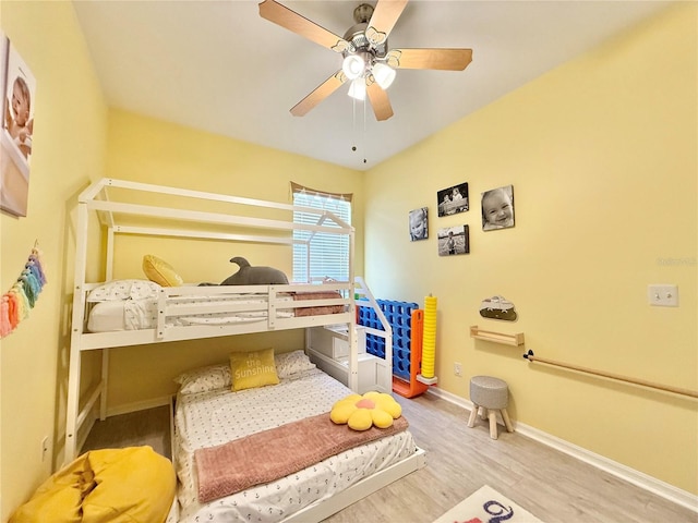 bedroom with baseboards, ceiling fan, and wood finished floors