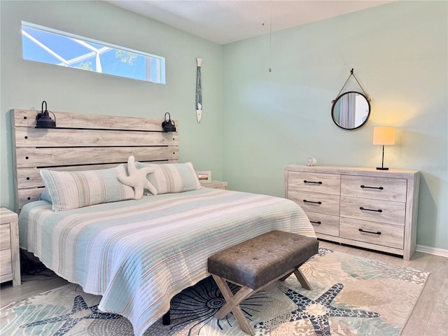 bedroom featuring light wood-type flooring and baseboards