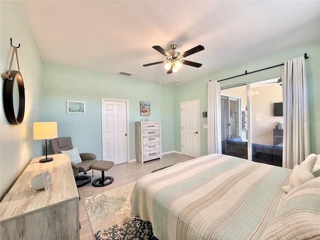 bedroom with visible vents, light wood-style floors, baseboards, ceiling fan, and access to outside