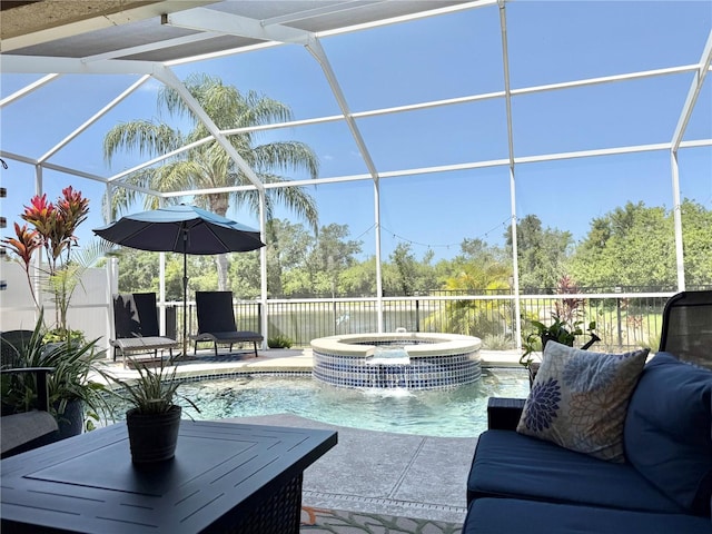 view of swimming pool with a patio, a pool with connected hot tub, and glass enclosure