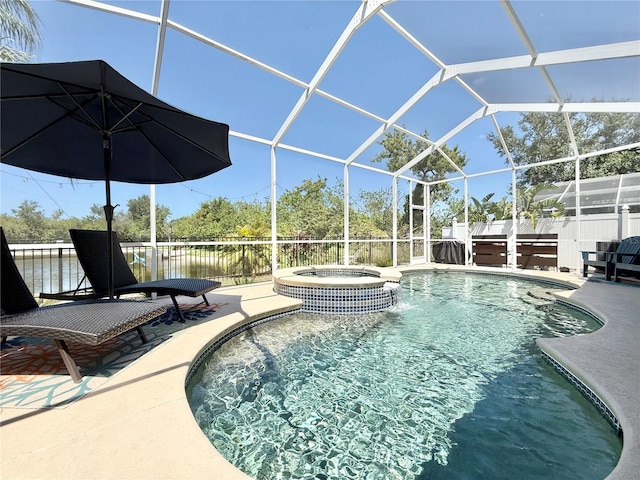 view of swimming pool with glass enclosure, a patio area, and a pool with connected hot tub