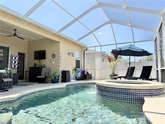 view of swimming pool with glass enclosure, a patio, ceiling fan, and a fenced in pool