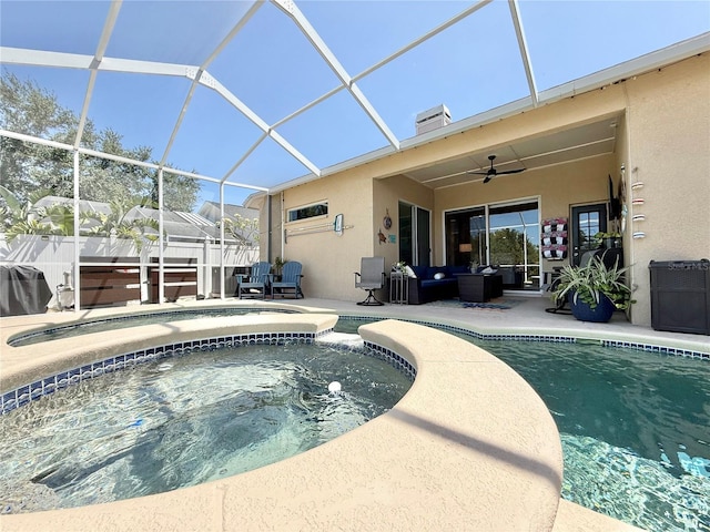 view of pool with ceiling fan, a patio, an outdoor living space, glass enclosure, and a pool with connected hot tub