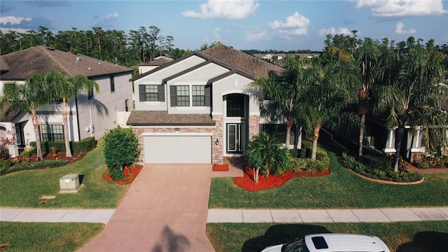 19314 Long Lake Ranch Blvd, Lutz, FL 33558 - view of front facade featuring driveway, stucco siding, stone siding, and a garage
