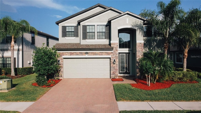 19314 Long Lake Ranch Blvd, Lutz, FL 33558 - view of front facade featuring stone siding, decorative driveway, stucco siding, an attached garage, and a front yard