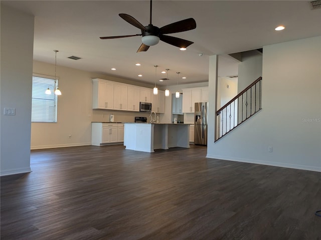 19314 Long Lake Ranch Blvd, Lutz, FL 33558 - kitchen with appliances with stainless steel finishes, open floor plan, baseboards, a ceiling fan, and dark wood-style floors