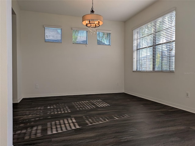 19314 Long Lake Ranch Blvd, Lutz, FL 33558 - unfurnished room featuring a chandelier, dark wood-style flooring, and baseboards