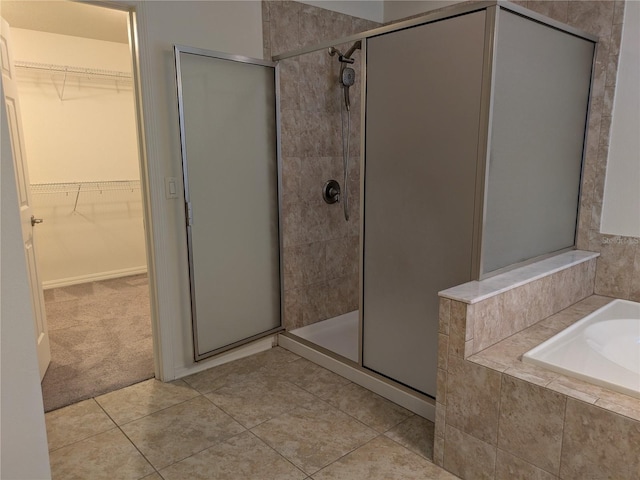 19314 Long Lake Ranch Blvd, Lutz, FL 33558 - full bathroom featuring a stall shower, a garden tub, tile patterned flooring, and a walk in closet