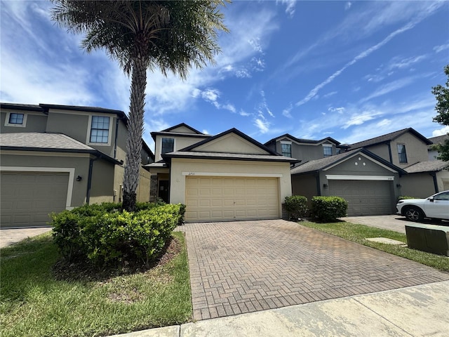 2731 Hampton Green Ln, Brandon, FL 33511 - traditional-style home with stucco siding, decorative driveway, and a garage