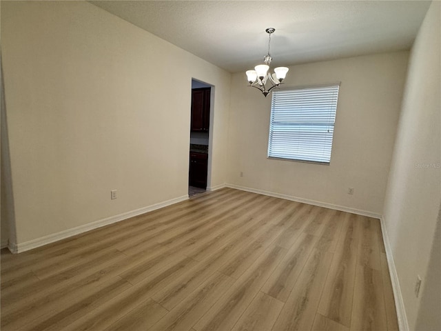 2731 Hampton Green Ln, Brandon, FL 33511 - spare room featuring a chandelier and light wood-type flooring