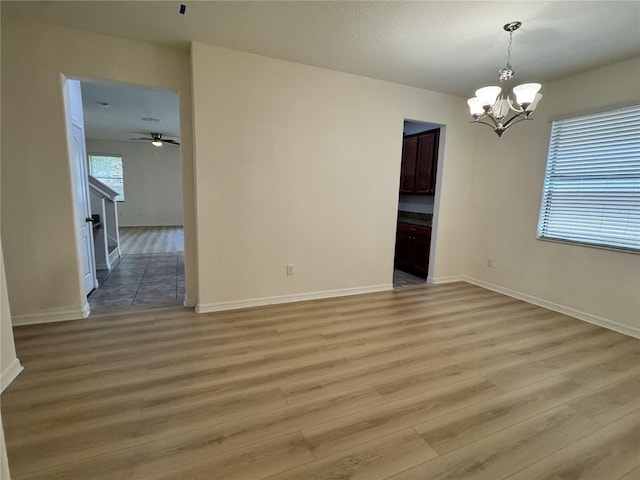 2731 Hampton Green Ln, Brandon, FL 33511 - unfurnished room with a chandelier, light wood-type flooring, and ceiling fan
