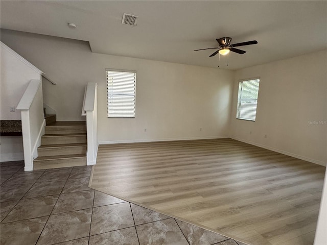 2731 Hampton Green Ln, Brandon, FL 33511 - unfurnished living room featuring ceiling fan, stairway, and wood finished floors