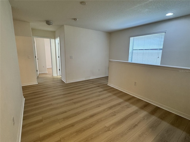 2731 Hampton Green Ln, Brandon, FL 33511 - spare room featuring wood finished floors, a textured ceiling, a smoke detector, and recessed lighting