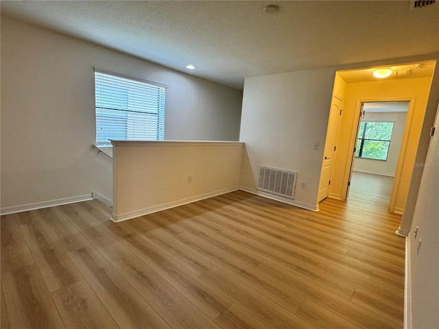 2731 Hampton Green Ln, Brandon, FL 33511 - empty room featuring light wood-style flooring, a textured ceiling, and recessed lighting
