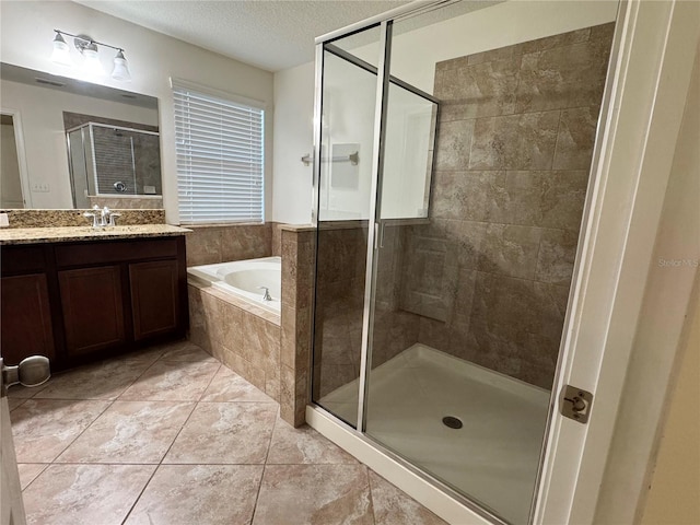 2731 Hampton Green Ln, Brandon, FL 33511 - full bathroom featuring a shower stall, a bath, vanity, a textured ceiling, and tile patterned floors