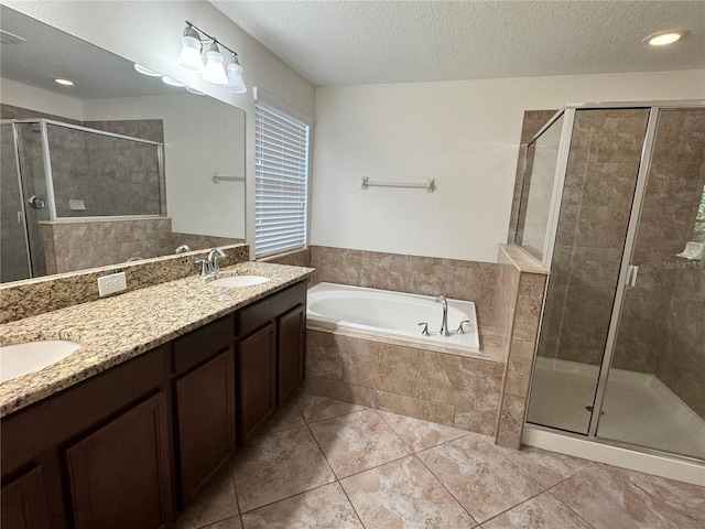 2731 Hampton Green Ln, Brandon, FL 33511 - bathroom with a garden tub, a shower stall, double vanity, a textured ceiling, and tile patterned flooring