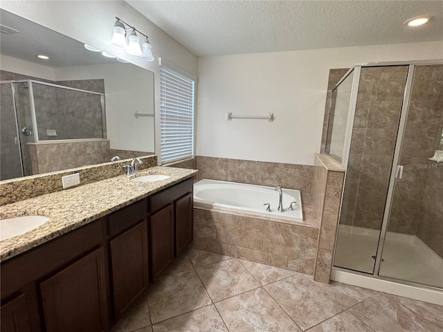 2731 Hampton Green Ln, Brandon, FL 33511 - bathroom featuring a bath, a stall shower, double vanity, tile patterned floors, and a textured ceiling