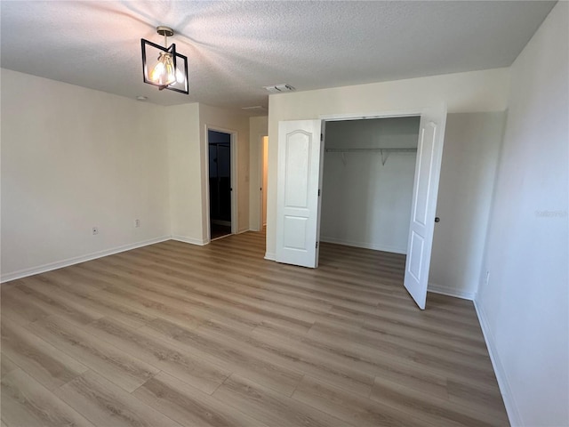 2731 Hampton Green Ln, Brandon, FL 33511 - unfurnished bedroom with a textured ceiling, light wood finished floors, and a closet