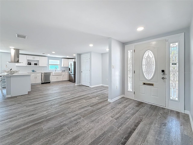 entrance foyer featuring recessed lighting, baseboards, visible vents, and wood finished floors