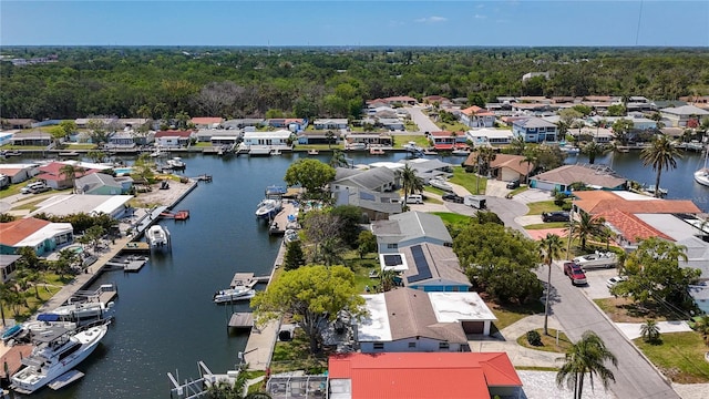 drone / aerial view with a water view, a residential view, and a forest view