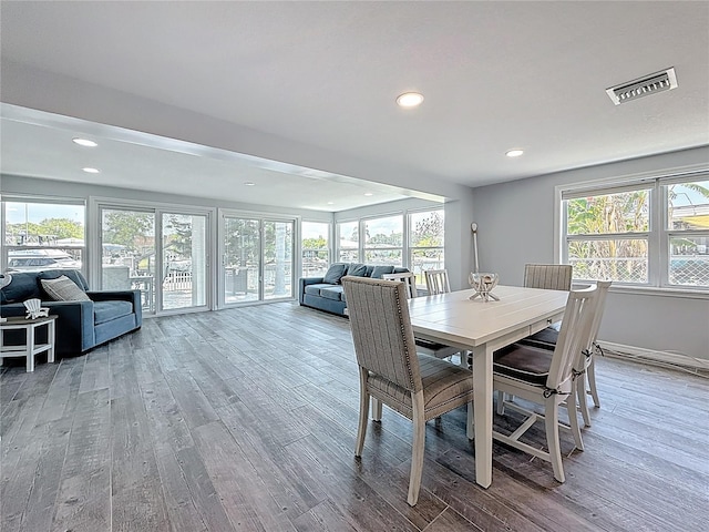 dining area with recessed lighting, wood finished floors, and visible vents