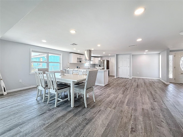 dining space featuring baseboards, recessed lighting, wood finished floors, and visible vents