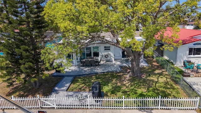 view of front facade with a patio and a fenced front yard