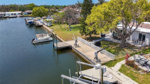 view of dock featuring boat lift, fence, and a water view
