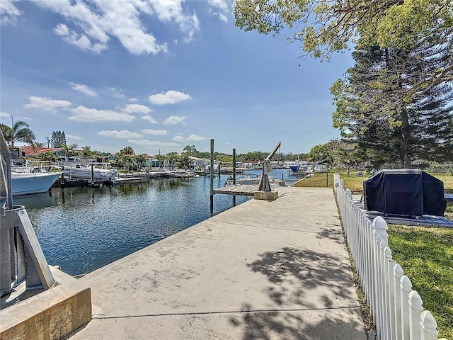 dock area with a water view and fence