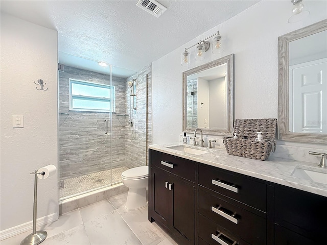 full bathroom featuring visible vents, a sink, toilet, and a shower stall