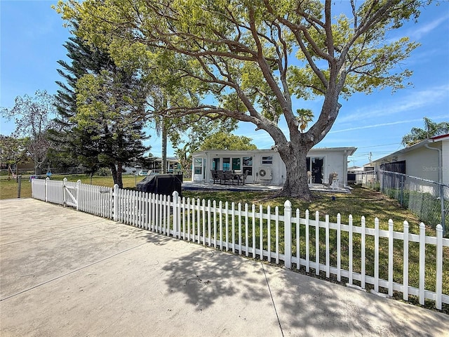 view of front of property with a front lawn and a fenced front yard