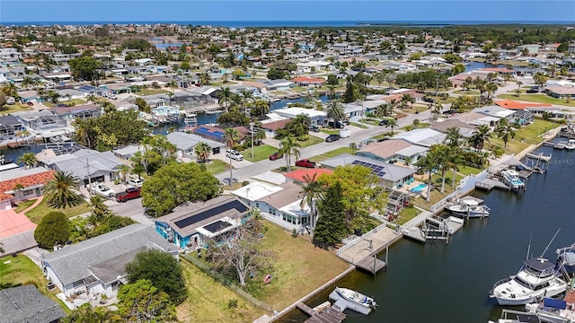 drone / aerial view with a residential view and a water view