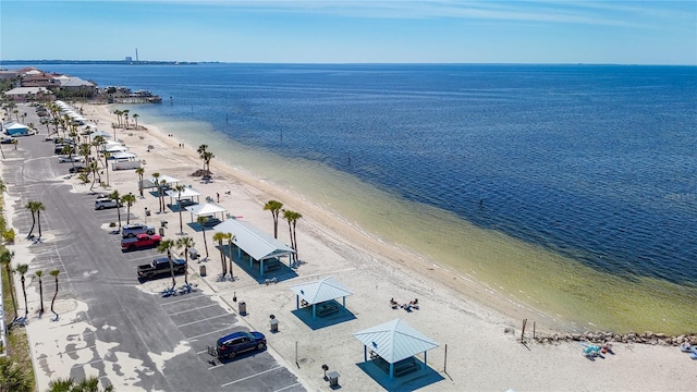 birds eye view of property featuring a beach view and a water view