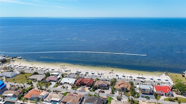 birds eye view of property featuring a water view, a residential view, and a beach view