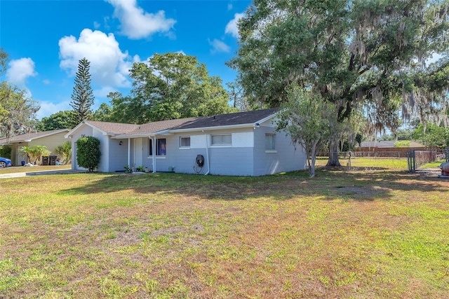 view of front of property with fence, a front yard, and concrete driveway
