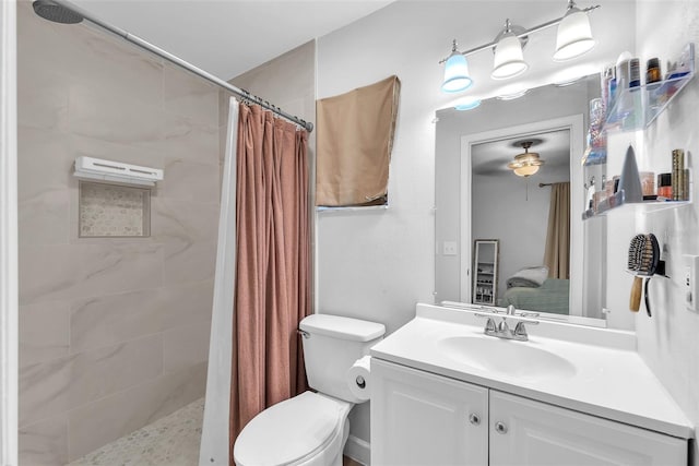 bathroom with vanity, toilet, and tiled shower