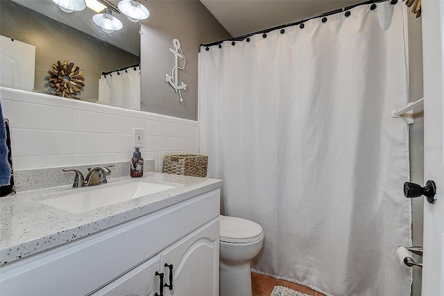 8497 137th St, Seminole, FL 33776 - full bath featuring toilet, tile walls, and vanity