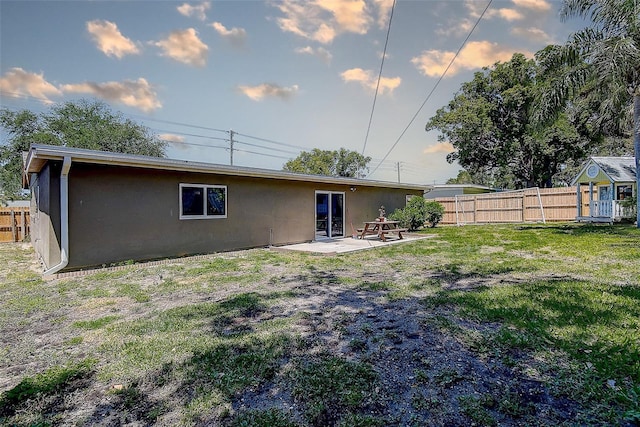 8497 137th St, Seminole, FL 33776 - back of property with a patio, a lawn, stucco siding, and fence
