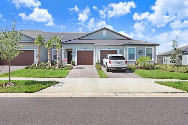 10998 Gable Dig Loop, San Antonio, FL 33576 - view of front of property with a garage, decorative driveway, and a front lawn