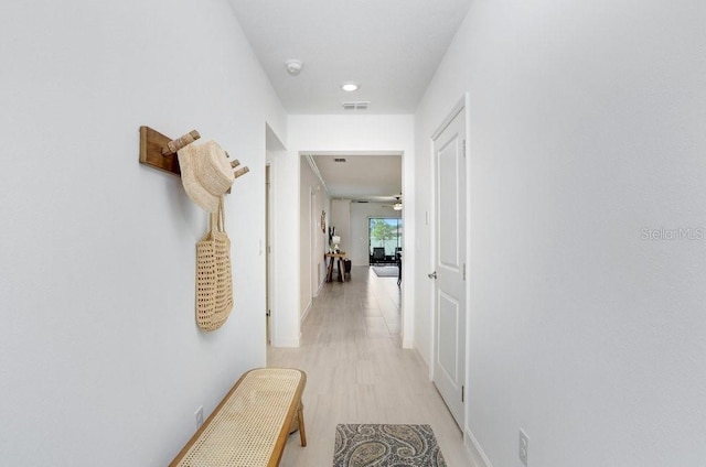 10998 Gable Dig Loop, San Antonio, FL 33576 - hall with visible vents, light wood-style flooring, and baseboards